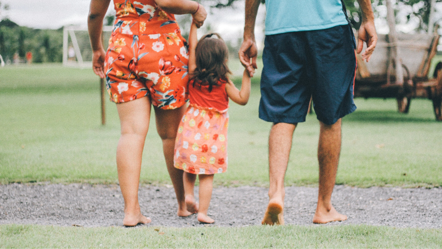 woman holding girls hand